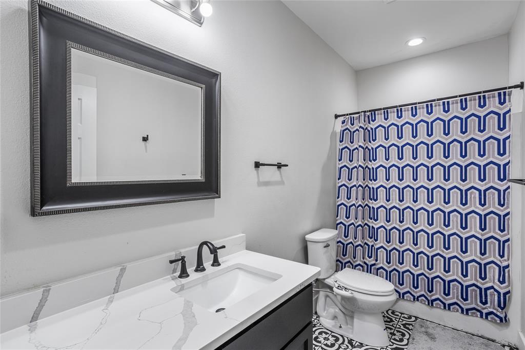 1685 Fleming Road Bells, TX 75414 - Photo 18 of 30 a bathroom with a sink toilet and mirror