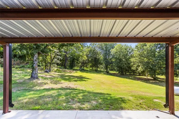 a view of a room with wooden floor and outdoor space