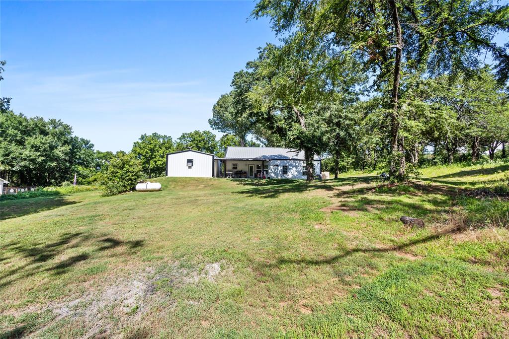 1685 Fleming Road Bells, TX 75414 - Photo 23 of 30 a front view of a house with a yard