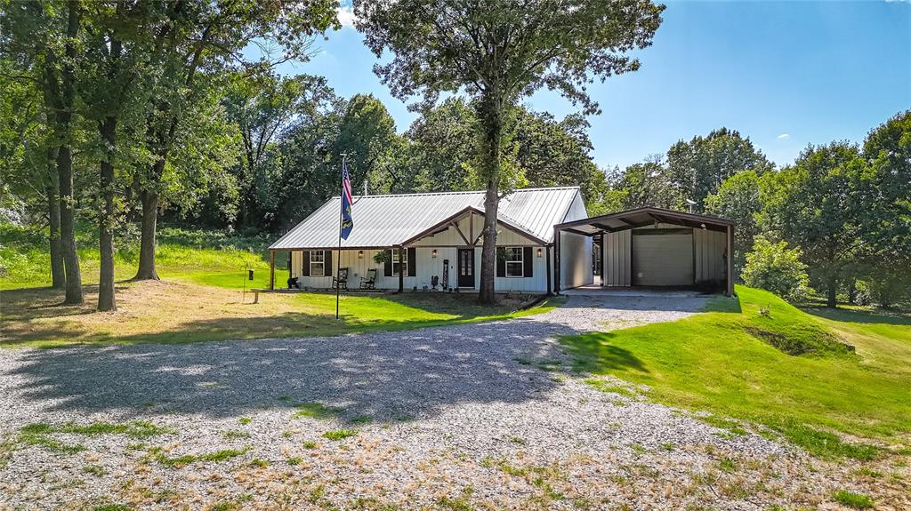 1685 Fleming Road Bells, TX 75414 - Photo 25 of 30 a view of a house with a yard and hanging chair