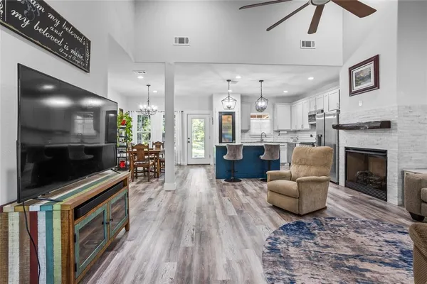 a living room with furniture a flat screen tv and a fireplace