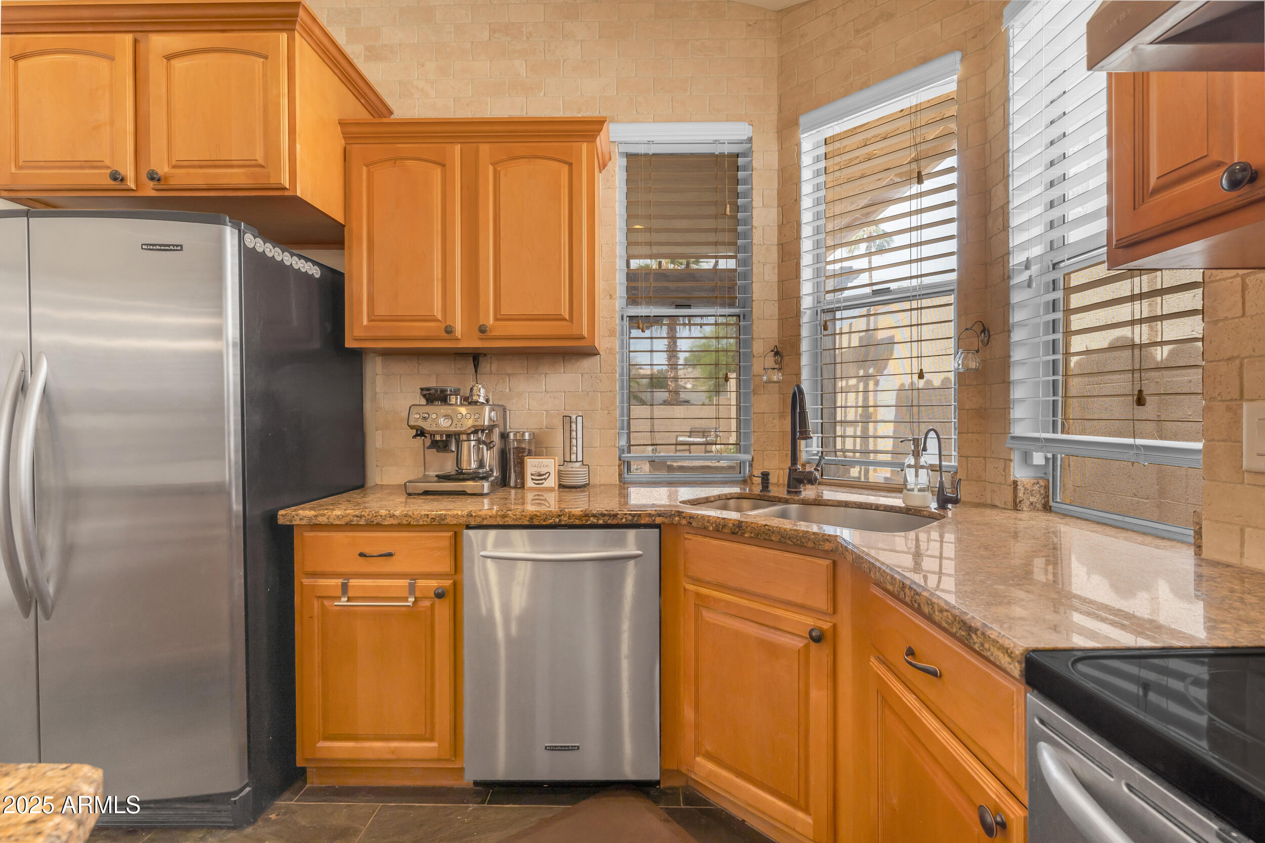 16044 South 24th Place Phoenix, AZ 85048 - Photo 13 of 42 a kitchen with stainless steel appliances granite countertop a stove a sink and a refrigerator
