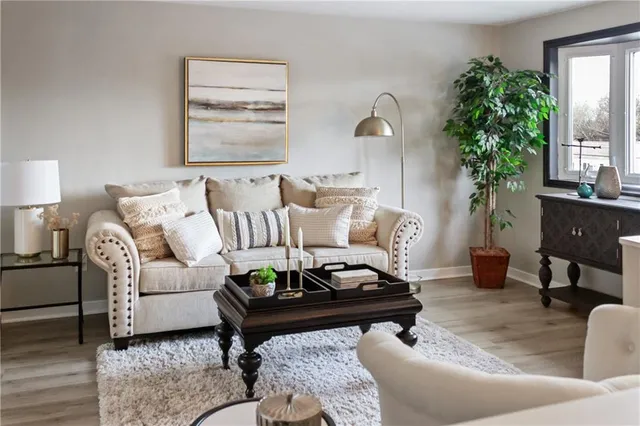 a living room with furniture and a potted plant