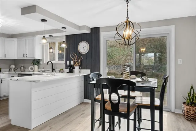a kitchen with a dining table and chairs