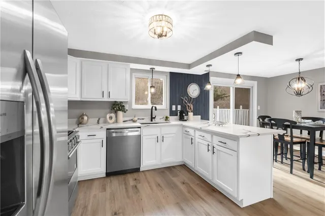 a kitchen with white cabinets and stainless steel appliances