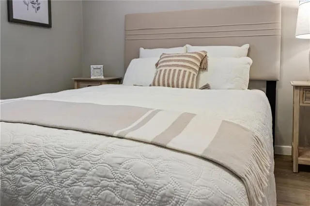 a bedroom with a bed and a lamp