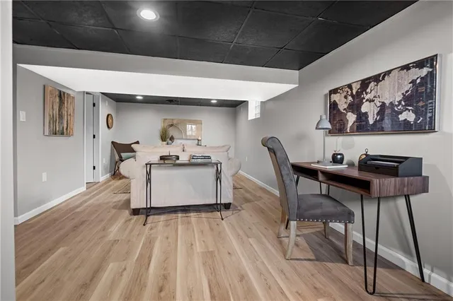 a living room with furniture and kitchen view