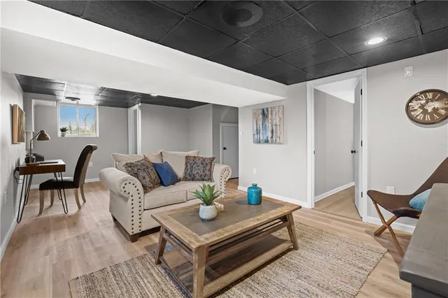 a living room with furniture and wooden floor