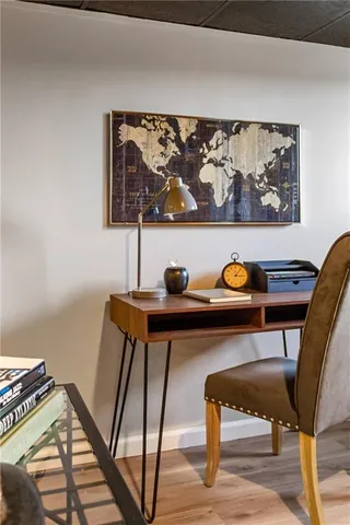 a view of a workspace with furniture and wooden floor