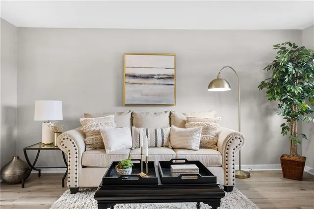 a living room with furniture and a potted plant