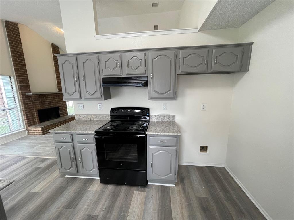 9415 Rutherglen Drive Dallas, TX 75227 - Photo 9 of 18 a kitchen with stainless steel appliances granite countertop a stove and a refrigerator