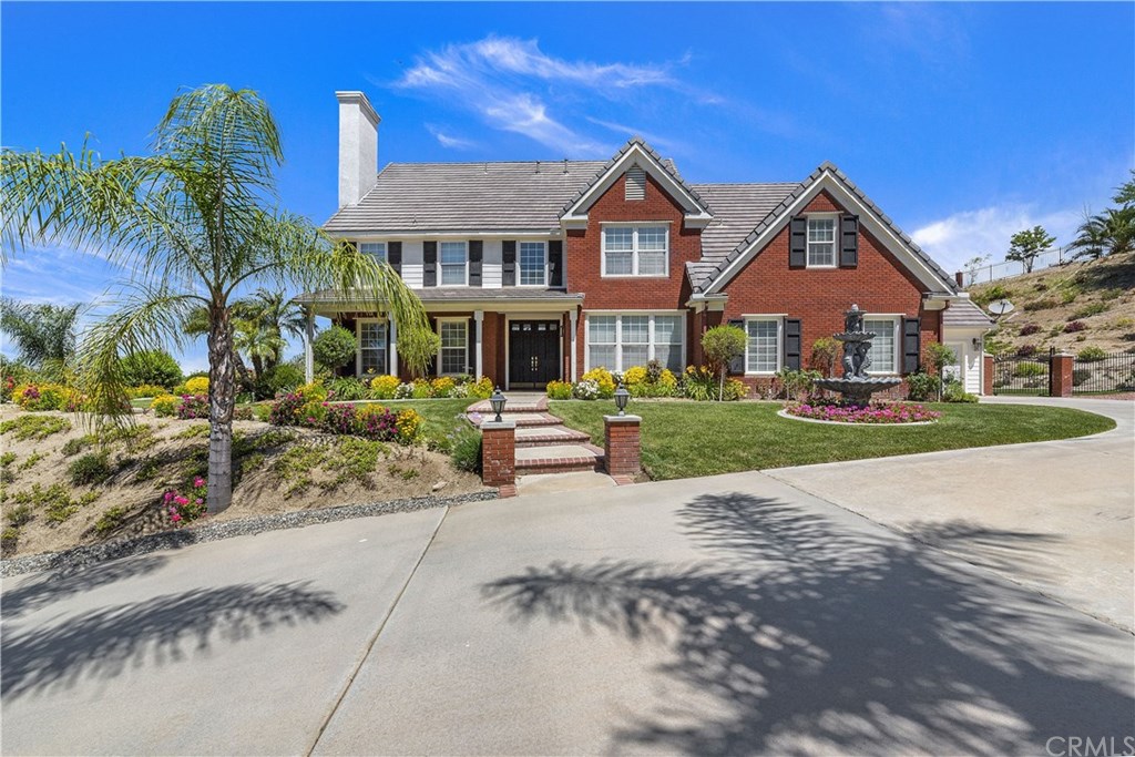 14070 Ashton Lane Riverside, CA 92508 - Photo 1 of 1 a front view of a house with a yard and potted plants