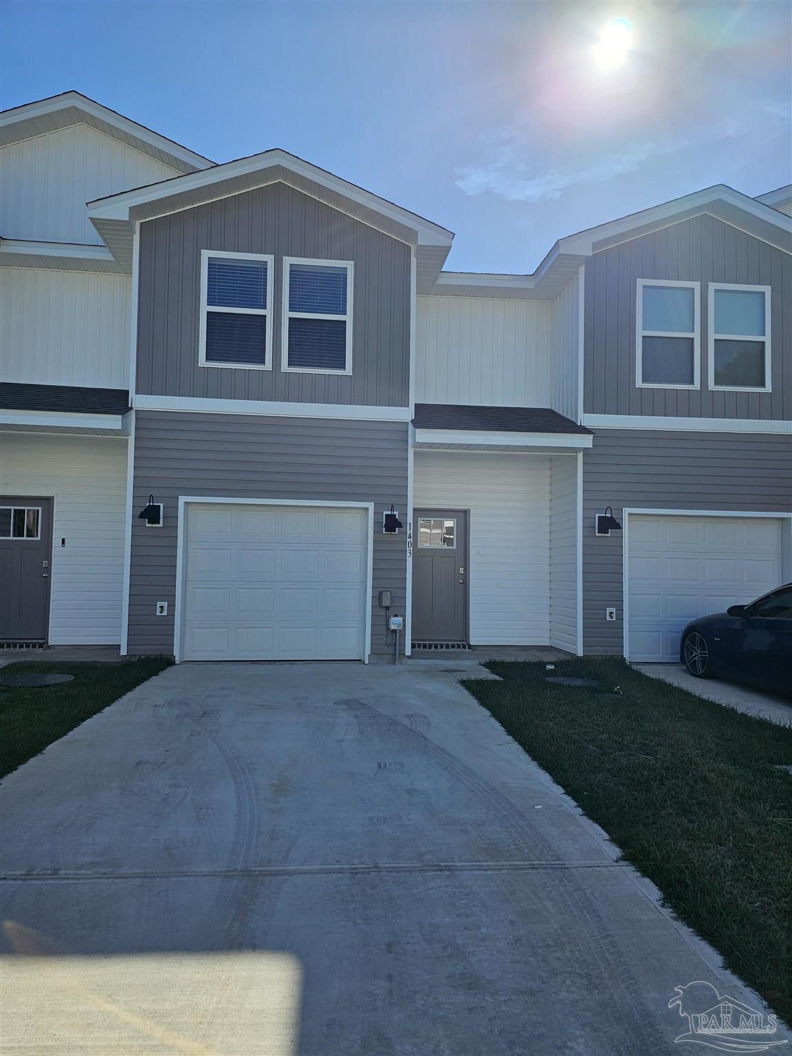 a view of backyard of house with green space
