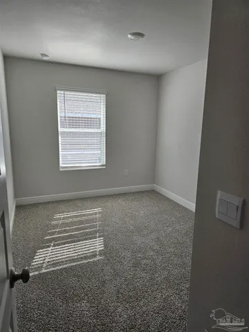 an empty room with a empty space and windows