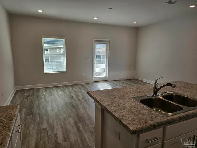 a kitchen with a sink and granite floor