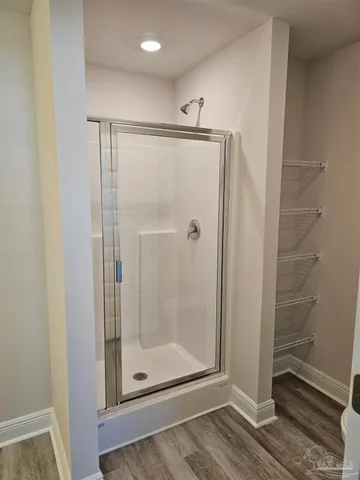 a bathroom with a glass shower door
