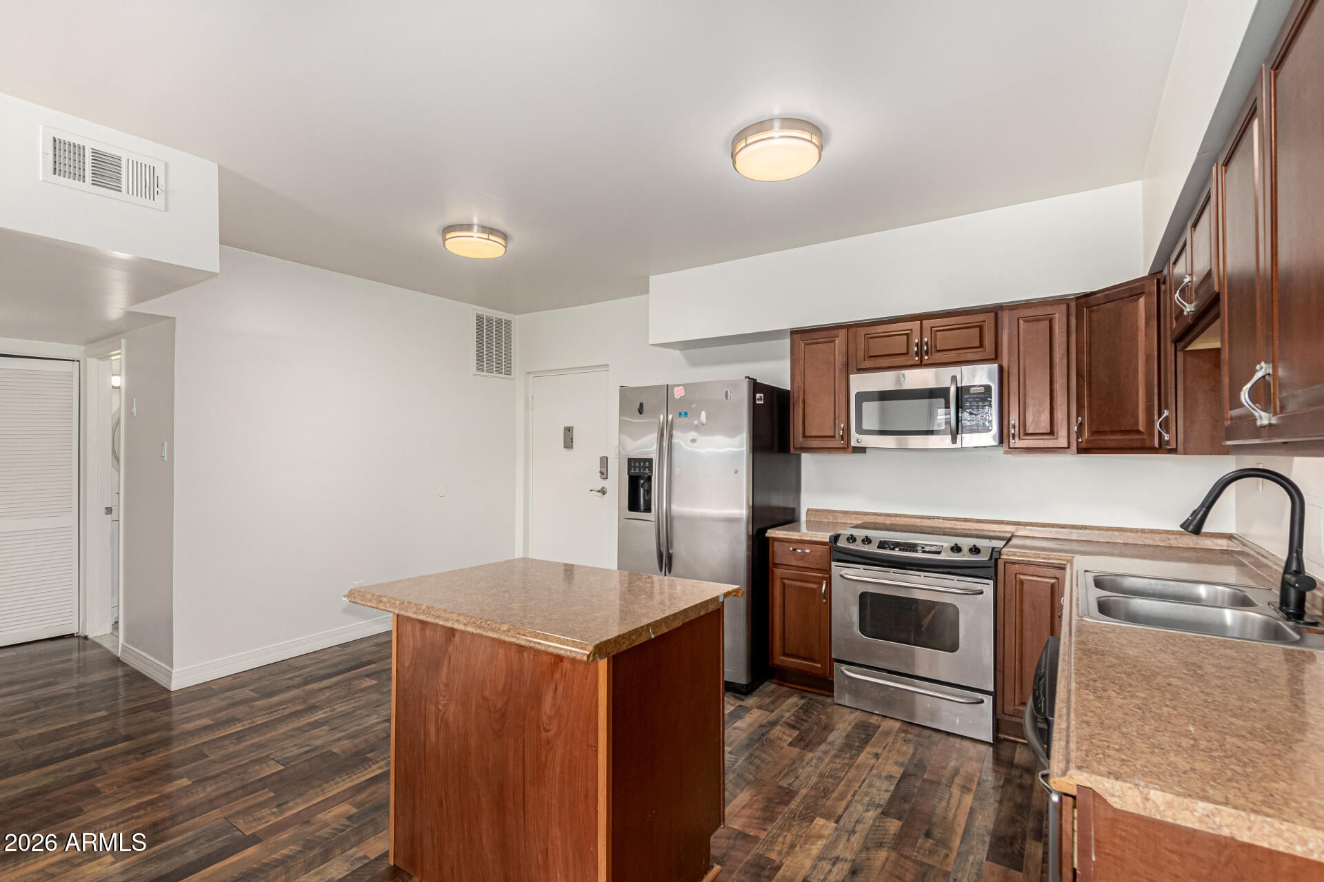 357 East Thomas Road, Unit A111 Phoenix, AZ 85012 - Photo 15 of 41 a kitchen with a stove a sink and a refrigerator