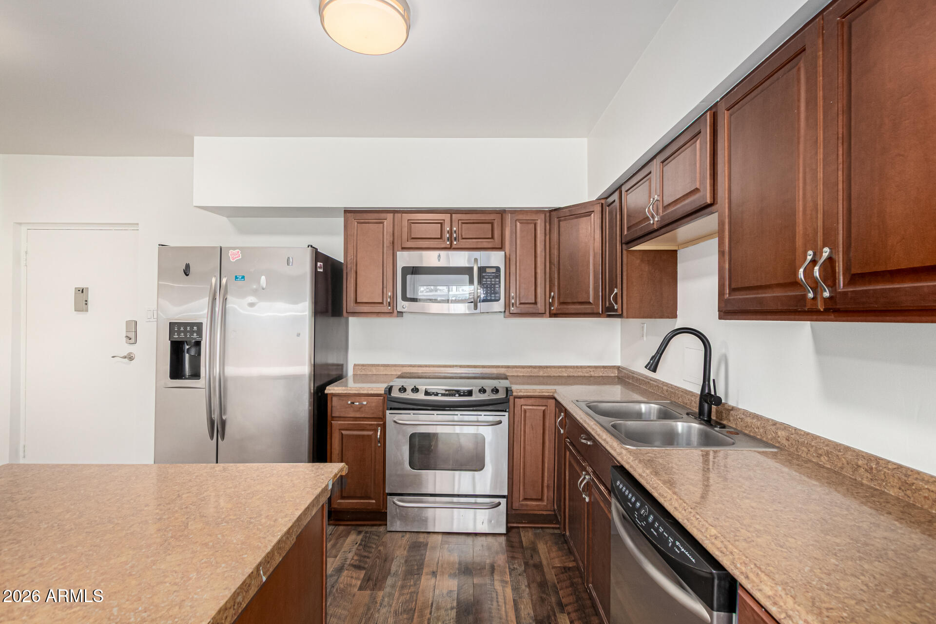 357 East Thomas Road, Unit A111 Phoenix, AZ 85012 - Photo 16 of 41 a kitchen with stainless steel appliances granite countertop a sink stove and refrigerator