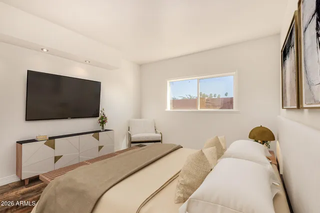 a bedroom with a bed and glass wall