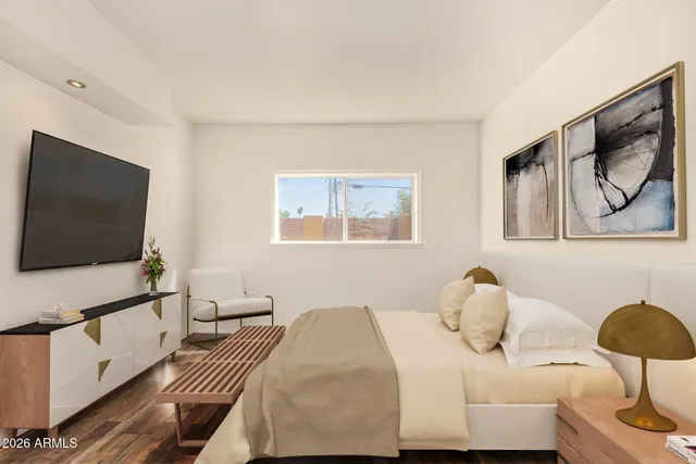 a bedroom with a bed and a flat screen tv