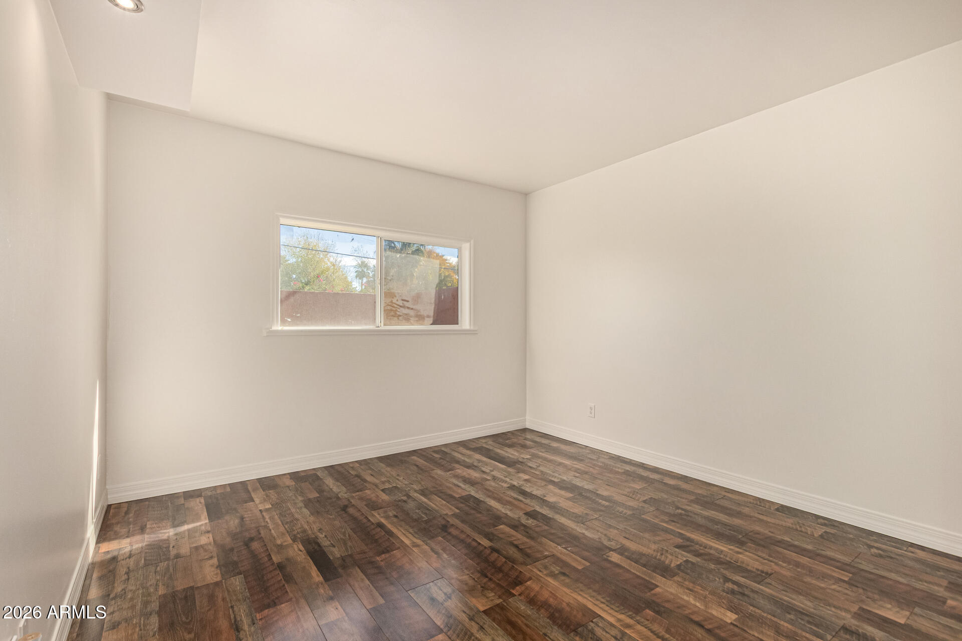 357 East Thomas Road, Unit A111 Phoenix, AZ 85012 - Photo 24 of 41 an empty room with wooden floor and windows