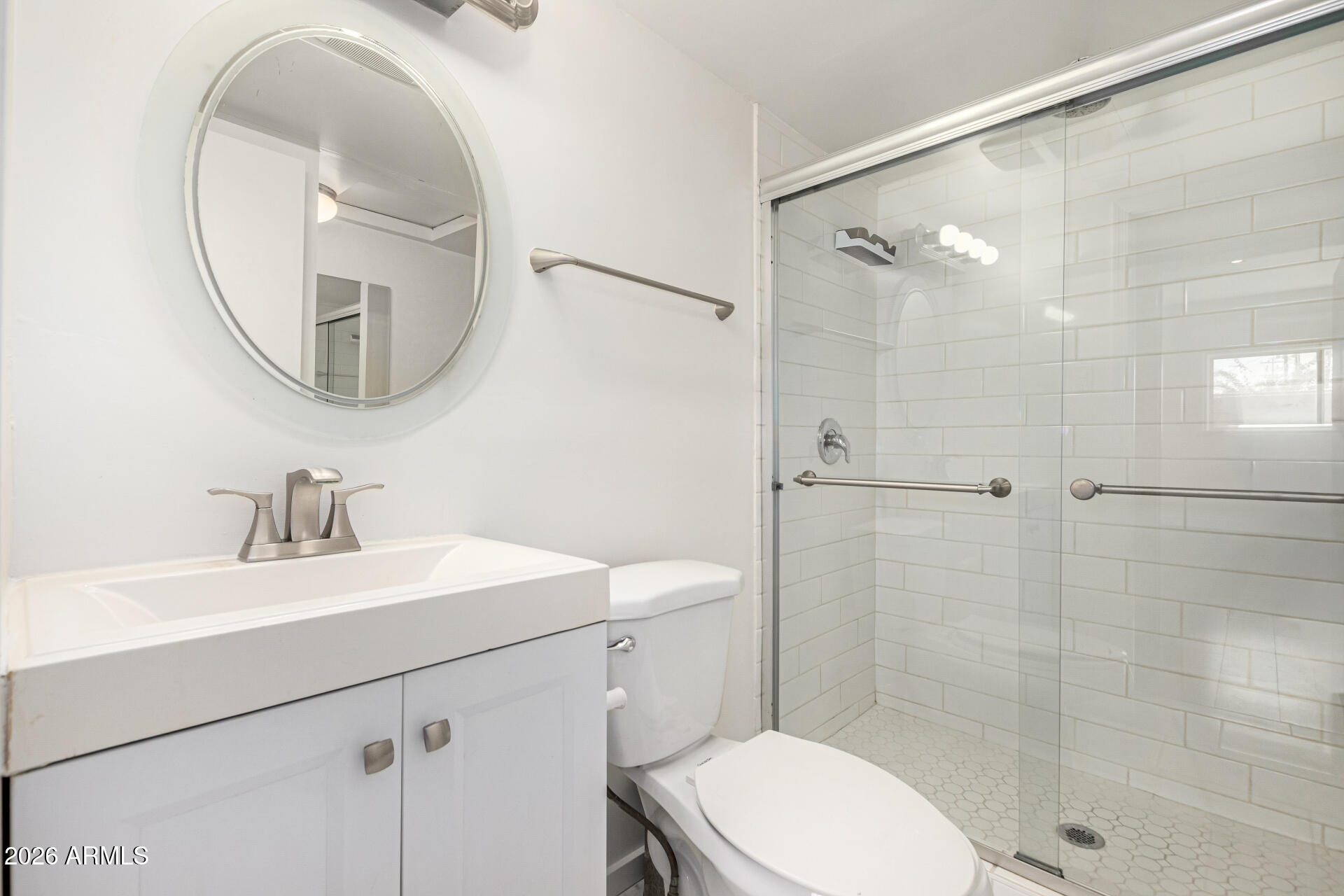 357 East Thomas Road, Unit A111 Phoenix, AZ 85012 - Photo 26 of 41 a bathroom with a sink a toilet and a mirror