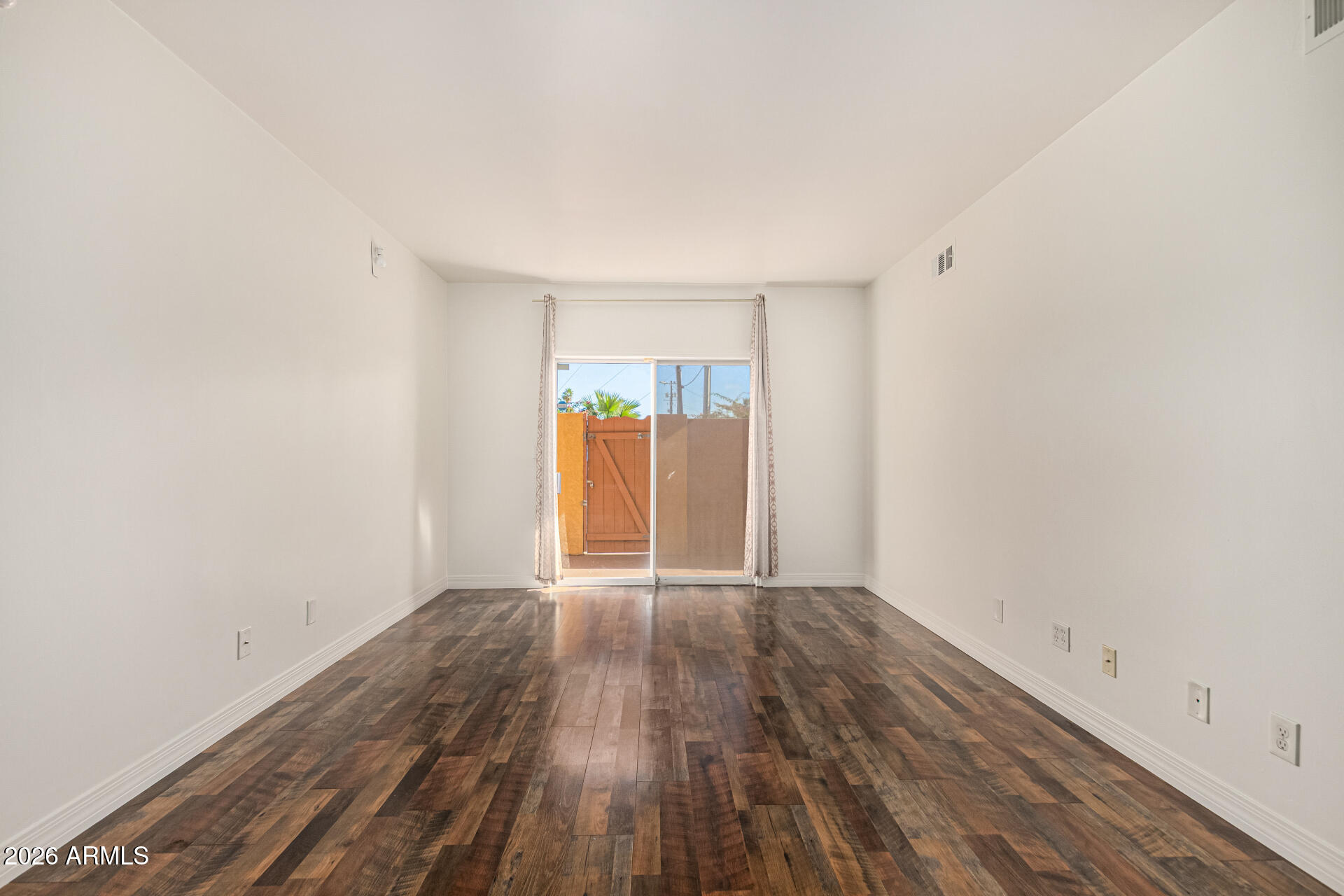 357 East Thomas Road, Unit A111 Phoenix, AZ 85012 - Photo 5 of 41 a view of an empty room with wooden floor
