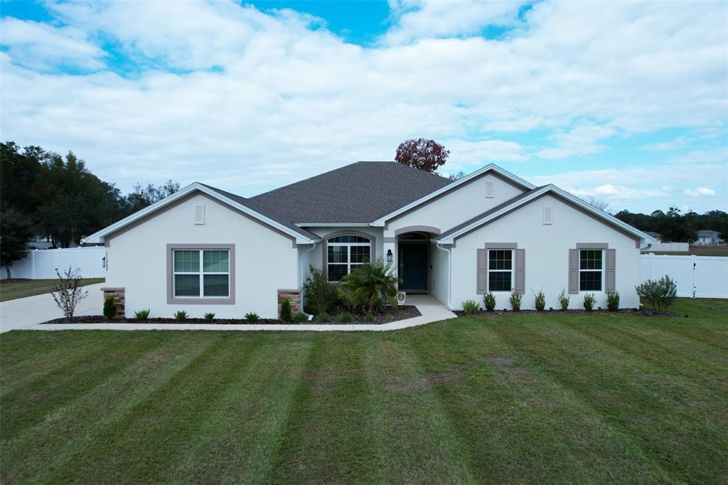 a front view of house with yard and green space