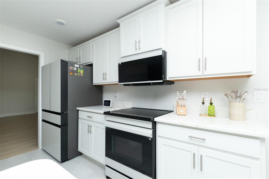 11267 Northwest 4th Street Ocala, FL 34482 - Photo 20 of 86 a kitchen with a sink stove and microwave