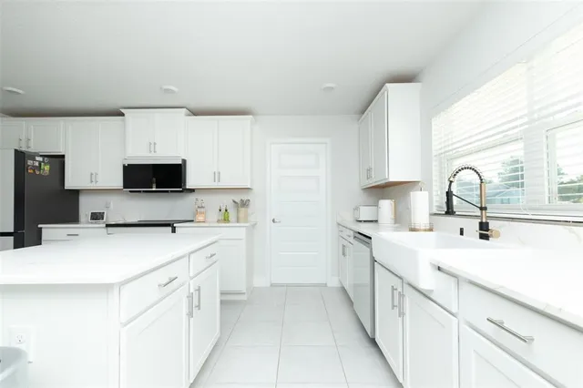 a spacious bathroom with a double vanity sink a mirror and a