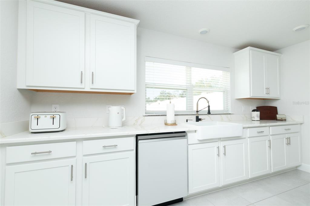 11267 Northwest 4th Street Ocala, FL 34482 - Photo 23 of 86 a kitchen with white cabinets and a sink