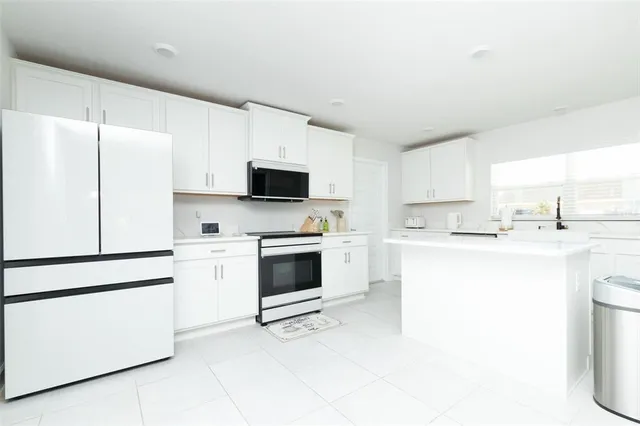 a spacious bathroom with a double vanity sink and a mirror