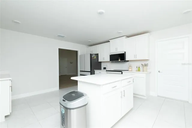 a spacious bathroom with a tub sink and mirror
