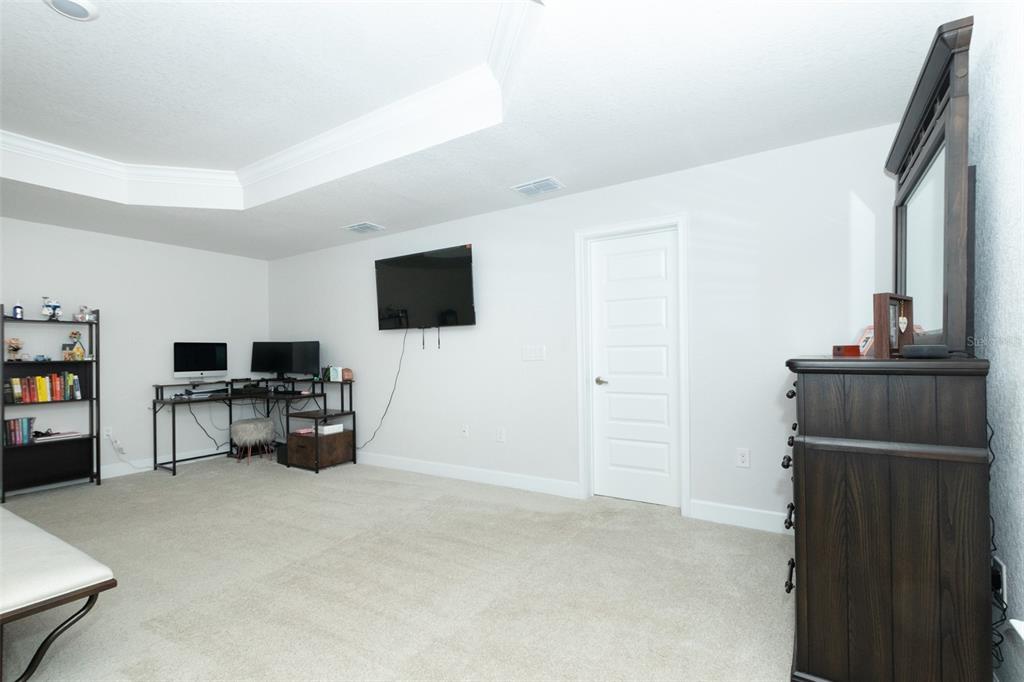11267 Northwest 4th Street Ocala, FL 34482 - Photo 28 of 86 a living room with furniture and a flat screen tv