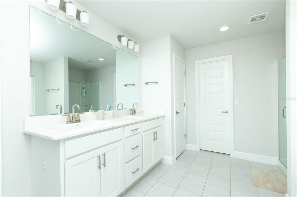 11267 Northwest 4th Street Ocala, FL 34482 - Photo 35 of 86 a spacious bathroom with a double vanity sink a mirror and a