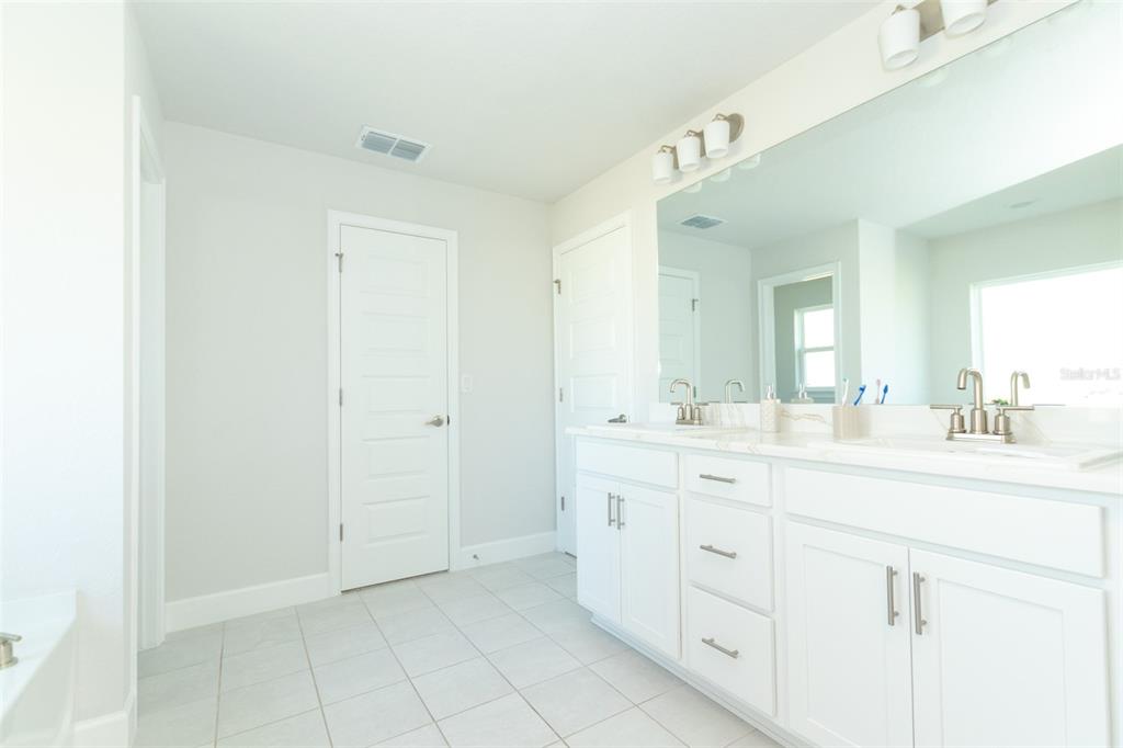 11267 Northwest 4th Street Ocala, FL 34482 - Photo 39 of 86 a spacious bathroom with a double vanity sink and a mirror