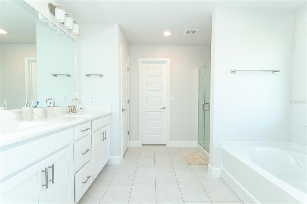 11267 Northwest 4th Street Ocala, FL 34482 - Photo 41 of 86 a spacious bathroom with a shower a sink and a bathtub