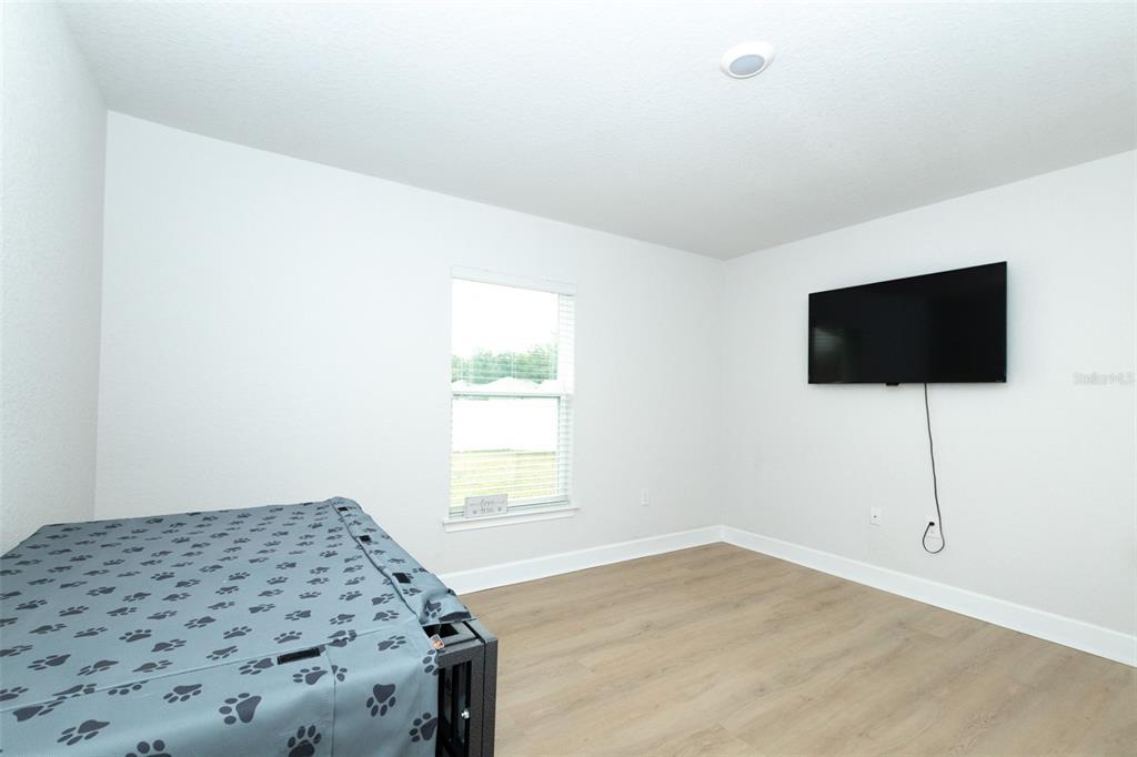 11267 Northwest 4th Street Ocala, FL 34482 - Photo 46 of 86 a bedroom with a bed and a flat screen tv