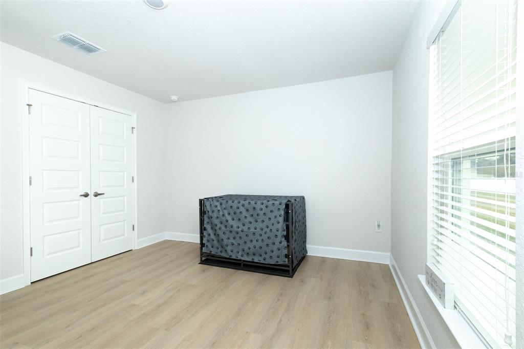 11267 Northwest 4th Street Ocala, FL 34482 - Photo 47 of 86 an empty room with wooden floor cabinet and windows