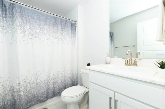 a view of a house with a big yard and large tree