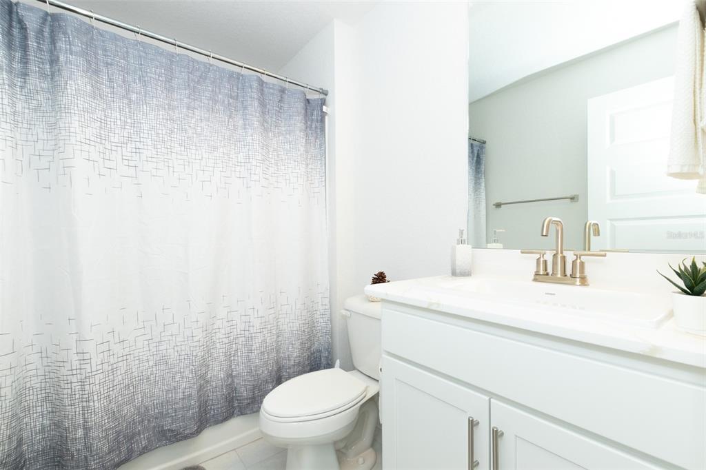 11267 Northwest 4th Street Ocala, FL 34482 - Photo 49 of 86 a bathroom with a sink a toilet and a mirror