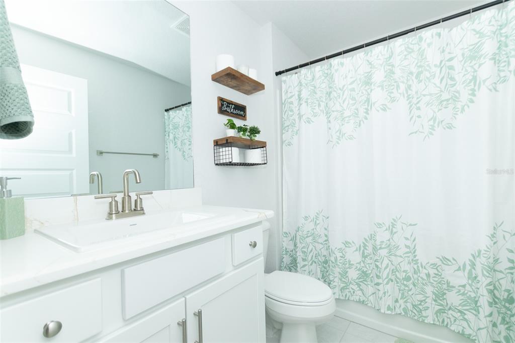 11267 Northwest 4th Street Ocala, FL 34482 - Photo 55 of 86 a bathroom with a sink a toilet and a mirror