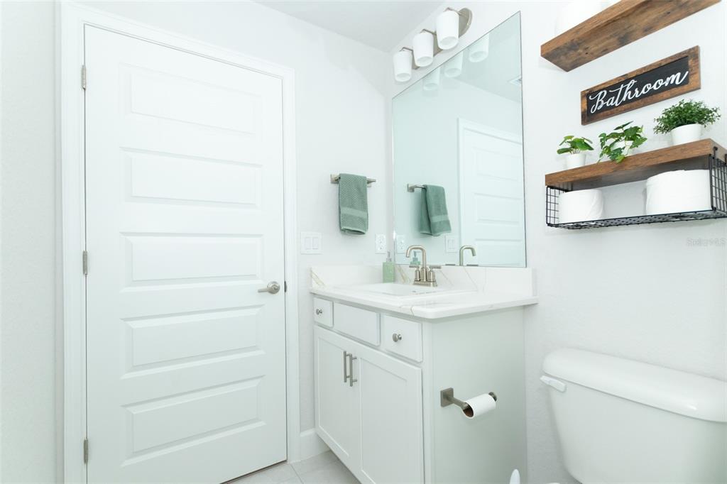 11267 Northwest 4th Street Ocala, FL 34482 - Photo 56 of 86 a bathroom with a sink a toilet and a mirror
