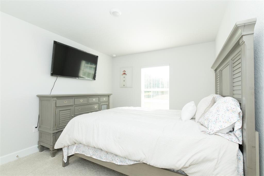 11267 Northwest 4th Street Ocala, FL 34482 - Photo 58 of 86 a bedroom with a bed and a flat screen tv