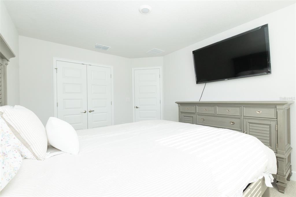 11267 Northwest 4th Street Ocala, FL 34482 - Photo 59 of 86 a bedroom with a bed and a flat screen tv