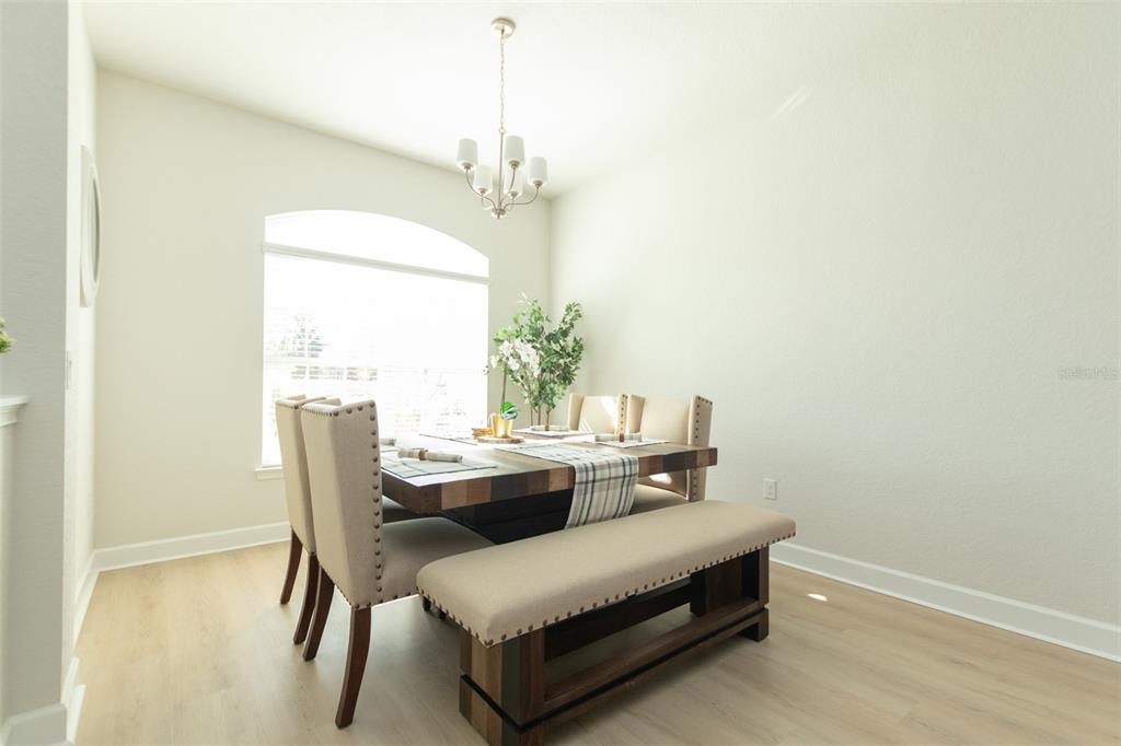 11267 Northwest 4th Street Ocala, FL 34482 - Photo 6 of 86 a view of a dining room with furniture and a chandelier