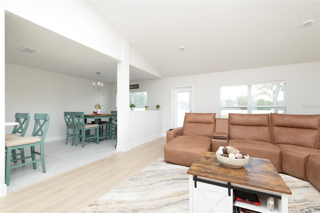 11267 Northwest 4th Street Ocala, FL 34482 - Photo 9 of 86 a living room with furniture and a dining table with kitchen view