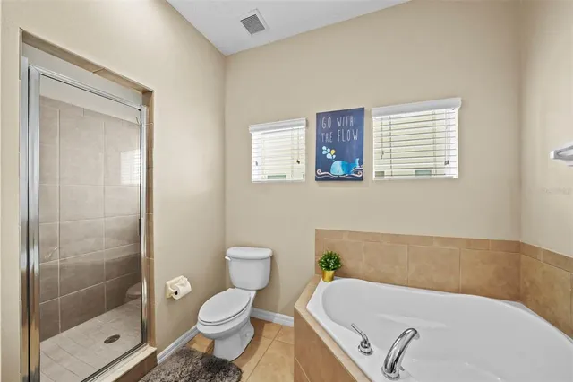 a bathroom with a tub toilet and shower