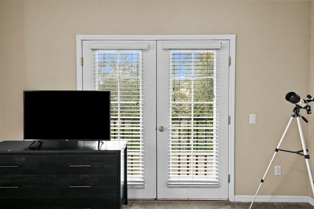 a living room that has a flat screen tv and a window