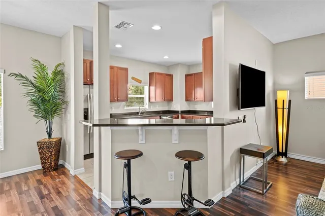 a living room with furniture a flat screen tv and a table